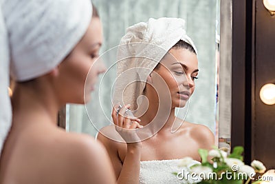 Woman spraying perfume on neck Stock Photo