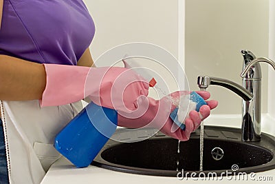 Woman squirting detergent onto a sponge Stock Photo