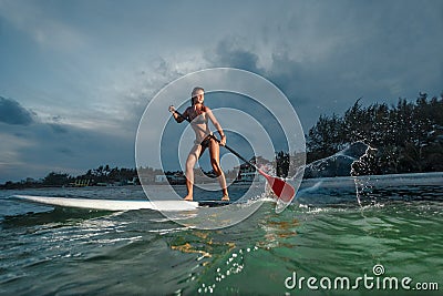 Woman stand up paddle boarding Stock Photo