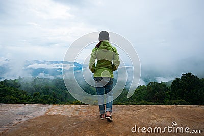 Woman standing alone wild mountains Stock Photo