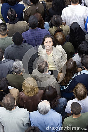 Woman Standing Amidst Around The People Stock Photo