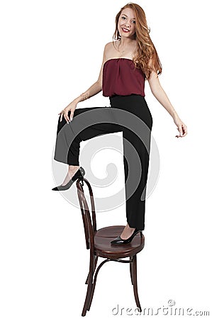 Woman Standing On Chair Stock Photo