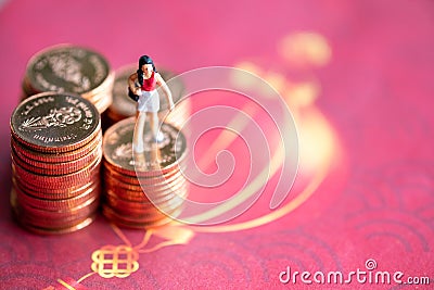 Woman standing on a coin Red background Financial concept Stock Photo