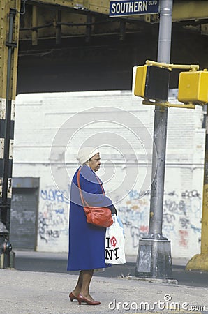 Woman standing on corner in poor neighborhood Editorial Stock Photo