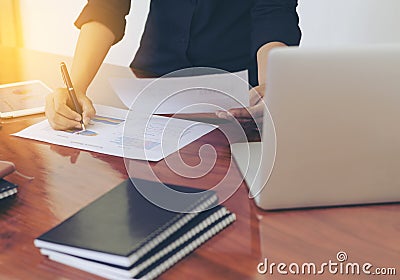 Woman standing at desk and working writing document hand close up. Stock Photo