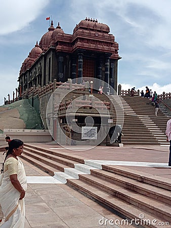 A woman is standing in front of an indian temple Editorial Stock Photo