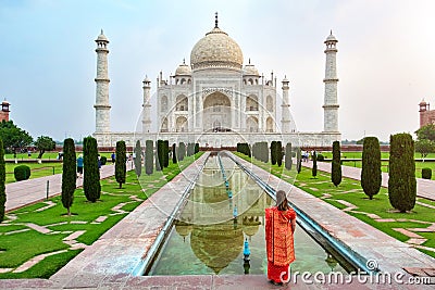 A woman standing front of Taj Mahal. Editorial Stock Photo