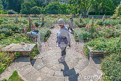 Woman standing in the middle of a circular staircase, Bodnant garden, Wales Editorial Stock Photo