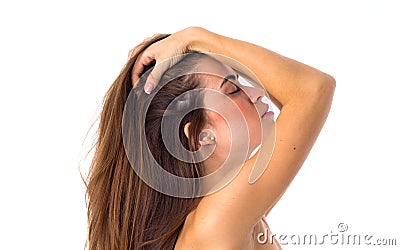 Woman standing sidewise and fixing hair Stock Photo