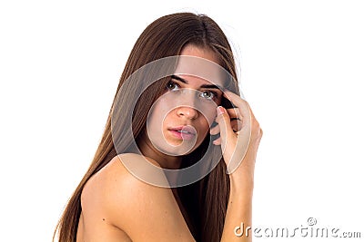 Woman standing sidewise and touching face Stock Photo