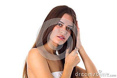Woman standing sidewise and touching hair Stock Photo
