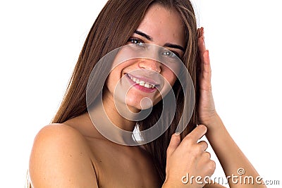 Woman standing sidewise and touching hair Stock Photo