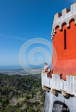 Woman stands on a high observation deck of the castle against the mountains Editorial Stock Photo