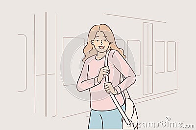 Woman stands near train car on platform of railway station and looks at screen smiling Vector Illustration
