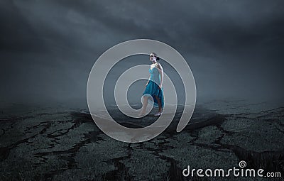 A woman stands on a solid rock Stock Photo