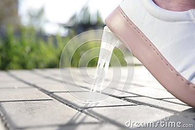 Woman stepping in chewing gum on sidewalk Stock Photo