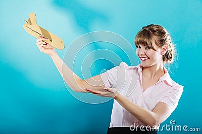 Woman stewardess invites to travel holds airplane Stock Photo