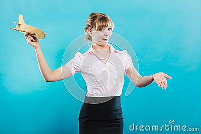 Woman stewardess invites to travel holds airplane Stock Photo