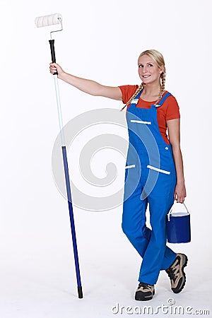 Woman stood with paint roller Stock Photo