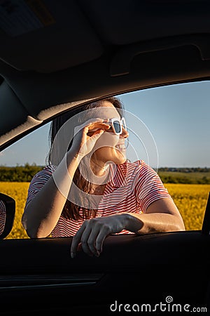 woman stop to enjoy sunset at road trip Stock Photo