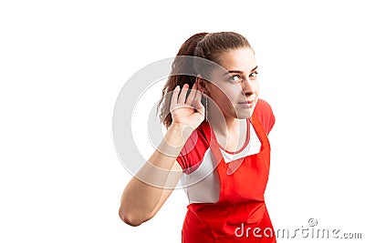 Woman storekeeper or retail worker making listening gesture Stock Photo