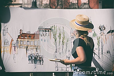 Woman street artist at work painting Editorial Stock Photo