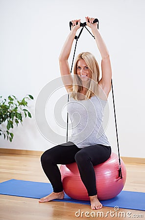 Woman strengthening her arm Stock Photo