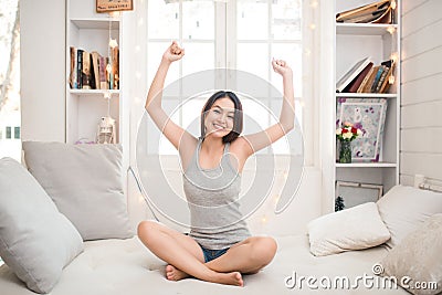 Woman stretching in bed after waking up, back view, entering a day happy and relaxed after good night sleep. Sweet dreams, good mo Stock Photo