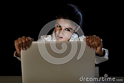 Woman or student girl working in darkness on laptop computer late at night holding the screen Stock Photo