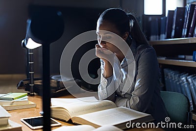 Woman studying late at night Stock Photo