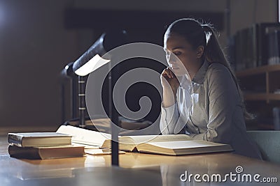 Woman studying late at night Stock Photo