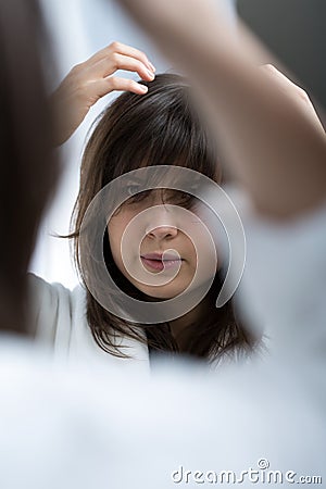 Woman styling hair Stock Photo