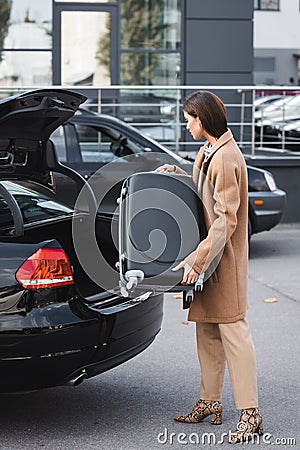 Woman in stylish autumn clothes loading Stock Photo