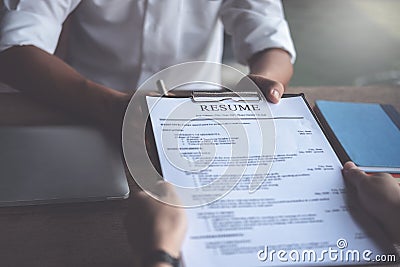 Woman submits job application, Interviewer reading a resume Stock Photo