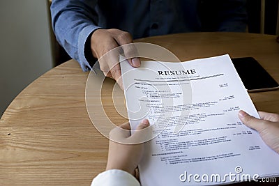 Woman submits job application, Interviewer reading a resume. Stock Photo