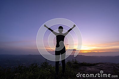 Woman successful hiking climbing silhouette in mountains Stock Photo