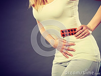 Woman suffer from belly pain holds pills Stock Photo