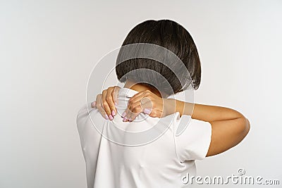 Woman suffer from neckpain after long office work at computer, massage neck to relief muscle strain Stock Photo