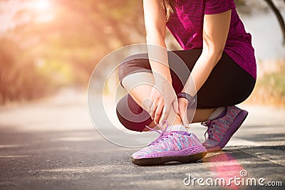 Woman suffering from an ankle injury while exercising. Running sport injury concept Stock Photo