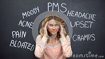 Woman suffering headache due to imaginary problems in pms, hormone imbalance Stock Photo