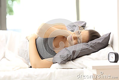 Woman suffering neck ache in an uncomfortable bed Stock Photo