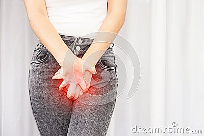 Woman suffering from pain, itchy crotch hand holding her burning vaginal caused by bladder infections or cystitis Stock Photo