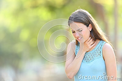 Woman suffering sore throat in a park Stock Photo