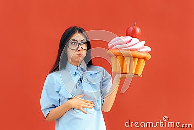 Woman Suffering Stomach Ache After Eating Too Much Cupcake Stock Photo