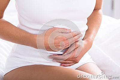 Woman Suffering From Stomach Pain Stock Photo