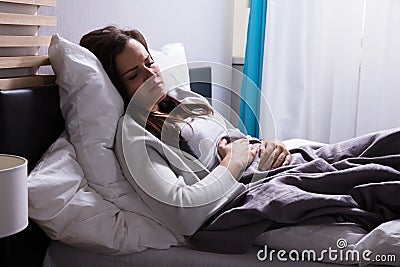 Woman Suffering From Stomach Pain Stock Photo