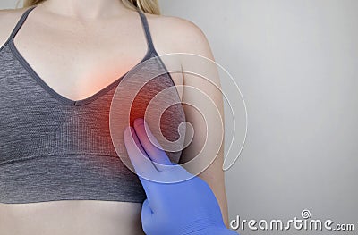 A woman suffers from chest pain. On examination by a gynecologist-mammologist. The concept of the prevention of breast diseases, Stock Photo