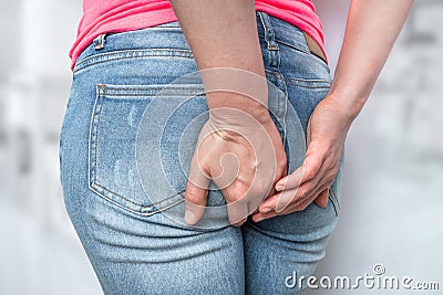 Woman suffers from diarrhea, she holding her butt Stock Photo