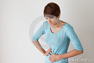 Woman suffers from menstruation pain or stomach ache Stock Photo