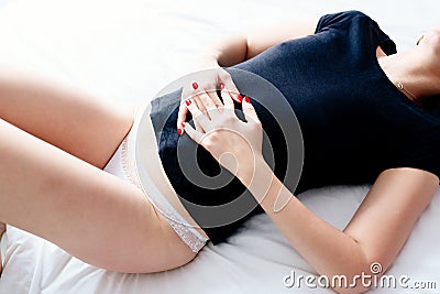 Woman suffers from menstruation pain or stomach ache Stock Photo